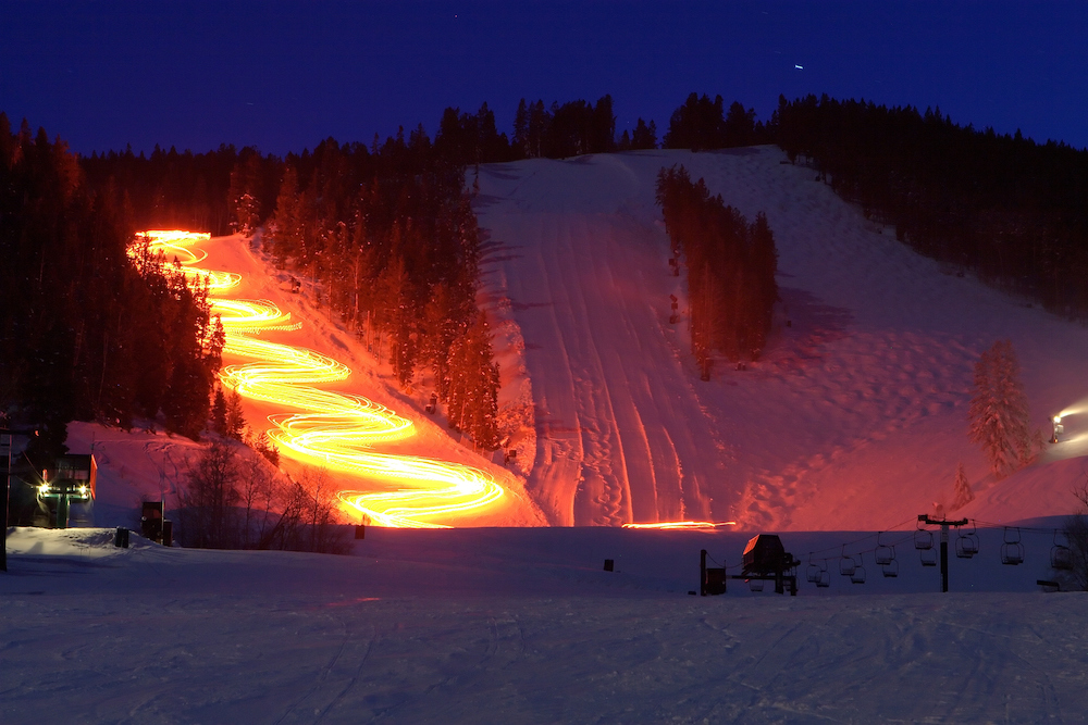 time lapse torchlight down snowy mountain 