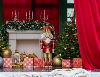 Large nutcracker doll standing beside presents