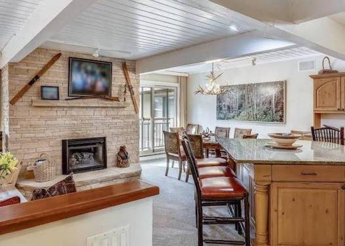 living and dining room at aspen chateau condo rental with neutral furnishings and mountain decor