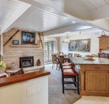 living and dining room at aspen chateau condo rental with neutral furnishings and mountain decor