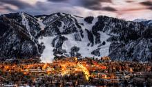 Aspen at dusk in winter with snow covered slopes in the background