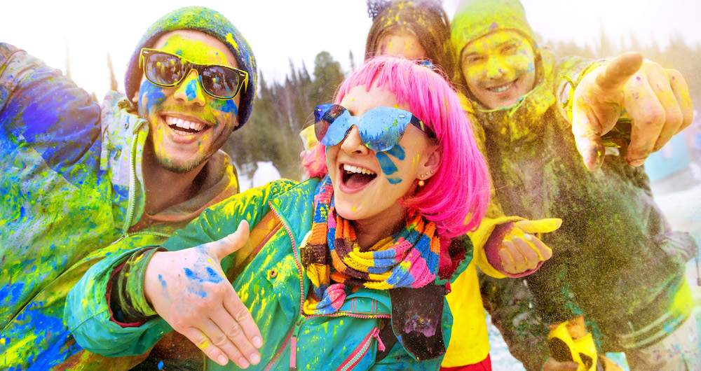 skiers with colorful paint powder on them
