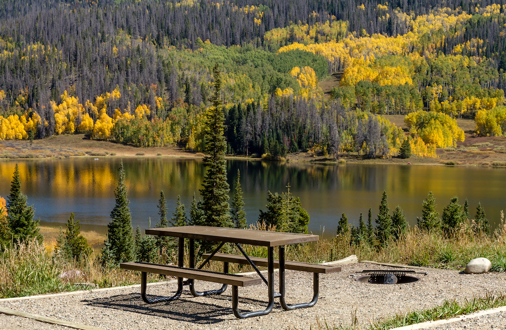 picnic table overlooking lake in Colorado during fall 